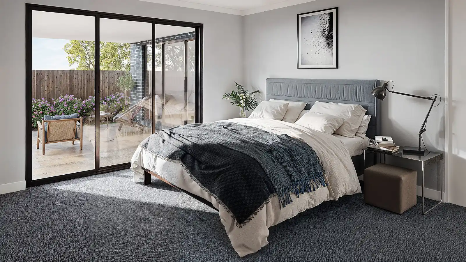High-quality 3D interior visualization of a modern bedroom featuring a bed with a grey upholstered headboard, dark carpeting, a bedside table with a black desk lamp, and large floor-to-ceiling sliding glass doors opening onto an outdoor patio with garden views.