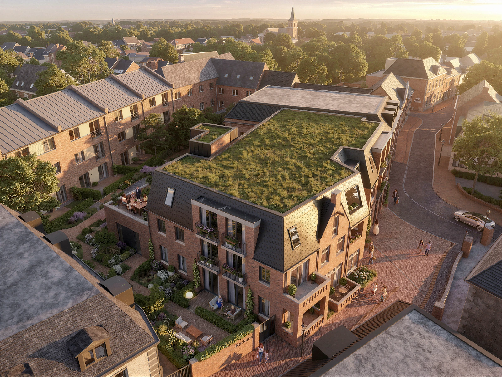 High-quality 3D aerial architectural visualization of a modern multi-story brick residential building integrated into a classic town setting . The architecture features a prominent eco-friendly green roof, dark sloped roof elements, dormer windows, and private balconies . Warm golden hour lighting illuminates the landscaped ground-level terraces, cobblestone streets with pedestrians and vehicles, and the surrounding neighborhood with a church spire visible in the distance.