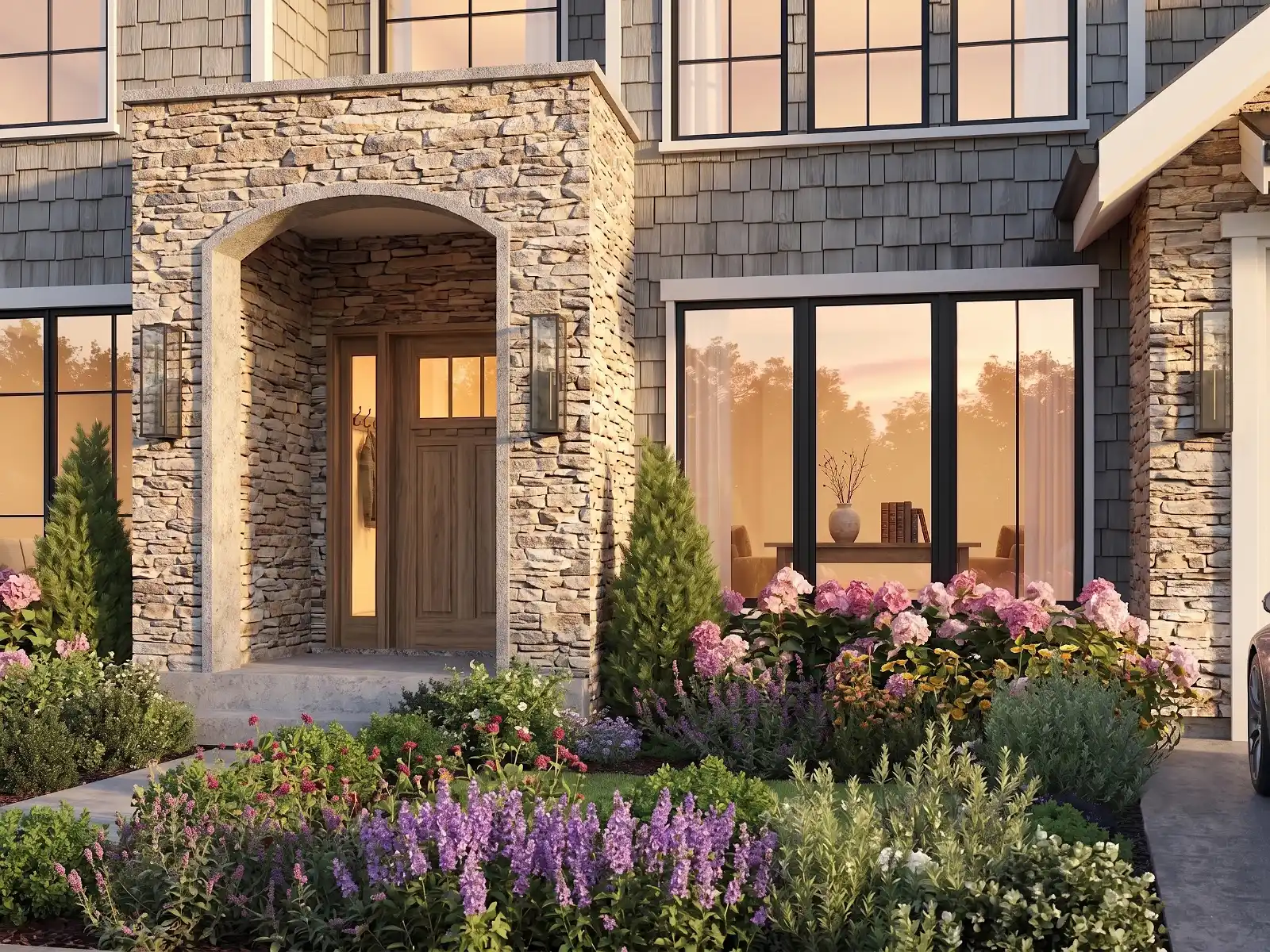 High-quality 3D architectural exterior visualization focusing on a residential home's front entrance. The scene features a prominent rustic stone archway, a classic wooden front door, grey shingle siding, and large black-framed windows reflecting the warm golden hour sunset. The foreground is beautifully landscaped with vibrant pink hydrangeas and purple flowers.